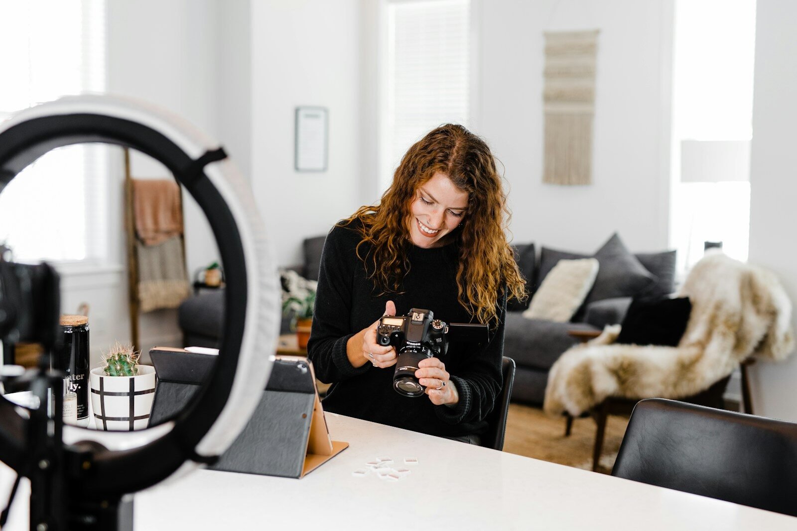 woman in black long sleeve shirt holding black dslr camera